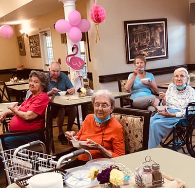 A group of seniors enjoying food at a themed party in Anderson, South Carolina.