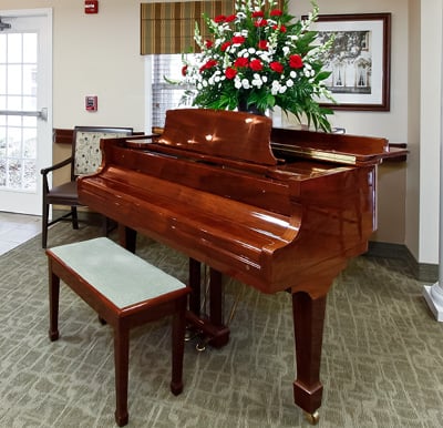 A grand piano with a large bouquet of roses on top in Anderson, South Carolina.