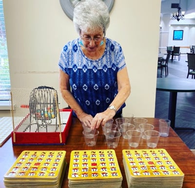 Woman setting up a game of bingo in the activity center in Raleigh, North Carolina.