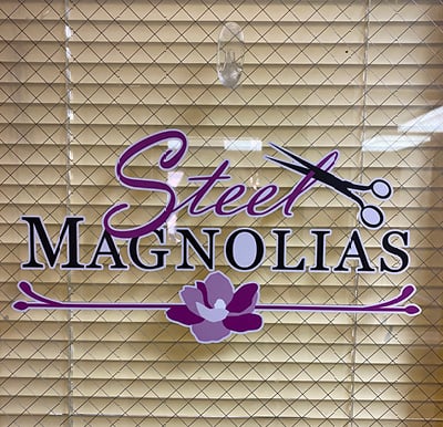 "Steel Magnolias" sign on door to Olde Raleigh beauty salon in Raleigh, North Carolina.