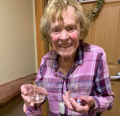 A resident holding samples of white and red wine during a happy hour event in Maple Grove, Minnesota.