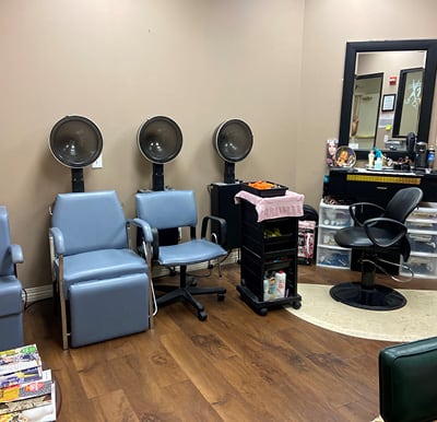 Rosemont's on-site beauty salon with multiple drying stations and a styling chair in Humble, Texas.