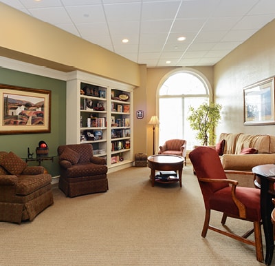 Bright, spacious library with well-stocked bookshelves and comfortable lounge seating in Springfield, Massachusetts.