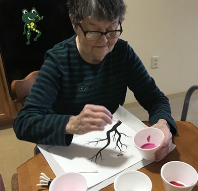 Senior women painting on a canvas in Macedonia, Ohio.