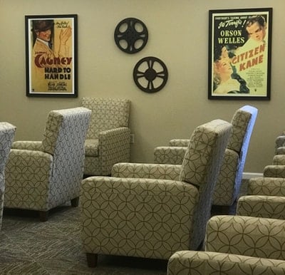 A movie theater room at a senior living community with reclining chairs in Macedonia, Ohio.