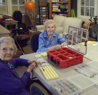 Residents participating in a jewelry making craft session in Anderson, South Carolina.