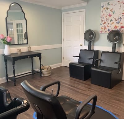 Clean and modern salon with multiple chairs and stations in Anderson, South Carolina.