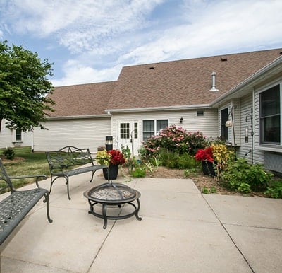 Landscaped courtyard with a patio, bench seating and a firepit in St. Joseph, Missouri.