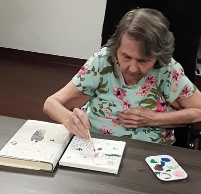 Woman painting in the activity center in Virginia Beach, Virginia.