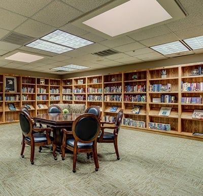 Library with books and seating area at a senior living facility in Hot Springs, Arkansas.