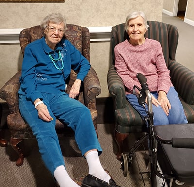 Two friends enjoying conversation in a comfortable lounge area in Columbiana, Ohio.