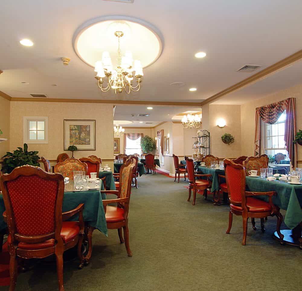 Dining room with fireplace and comfortable seating at a senior living community in Shaker Heights, Ohio.