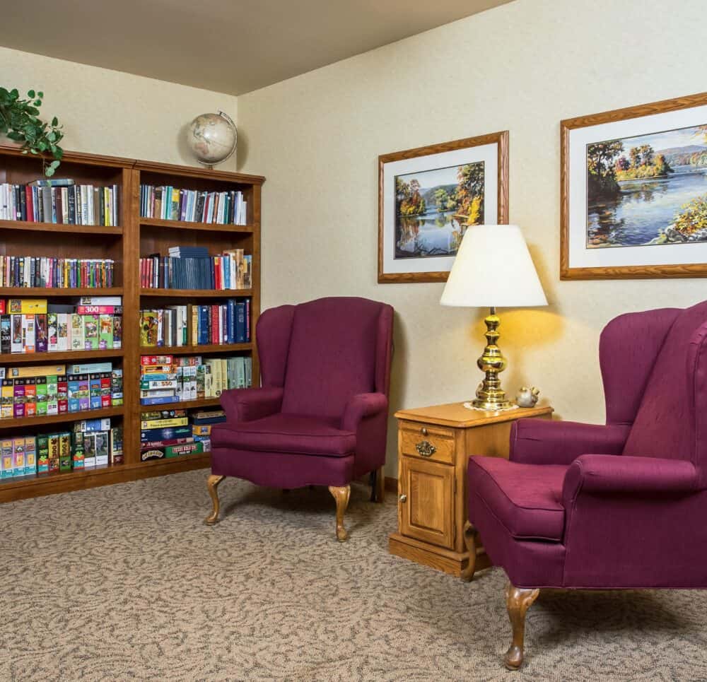 Library with seats at a senior living community located in West Bend, Wisconsin.