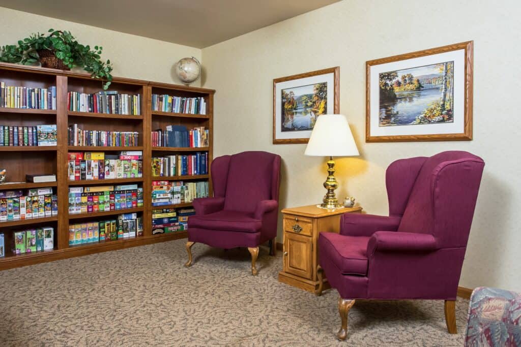 Library with seats at a senior living community located in West Bend, Wisconsin.
