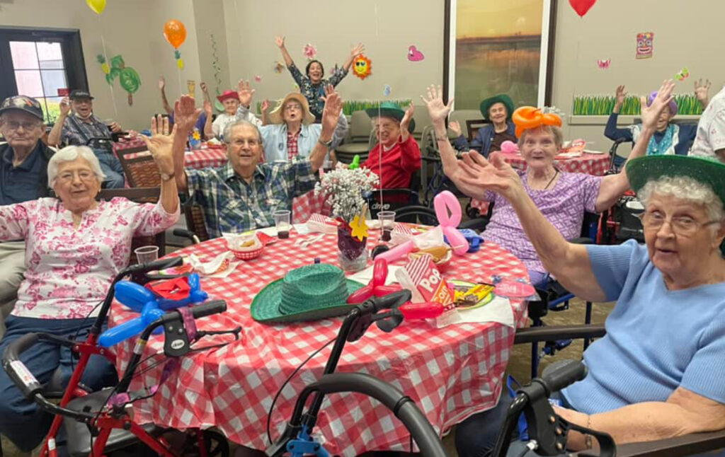 Group of older adults have fun at a carnival-themed party at their senior living community in Cottonwood, Arizona.