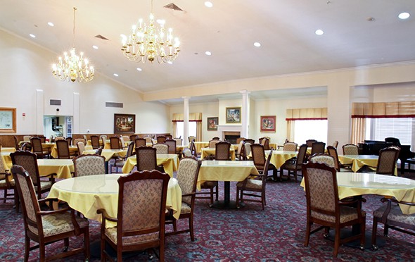 Large, formal dining room with many tables and elegant chandeliers in Fort Worth, Texas.