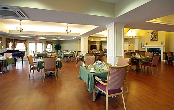 Spacious dining room with ample seating and a fireplace in Hamilton, Ohio