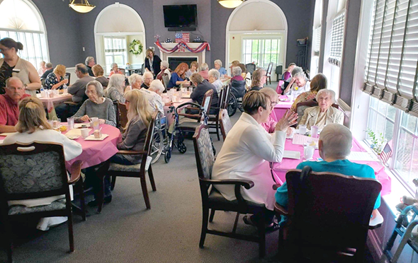 Residents and their families enjoying a meal in the community dining room during a holiday celebration in Columbiana, Ohio