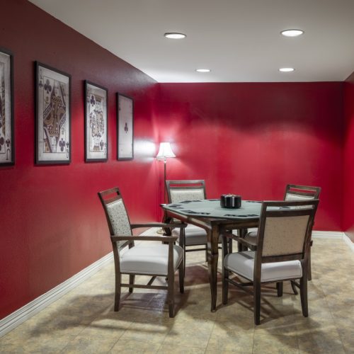 The red game room includes a game table for four people to play cards together