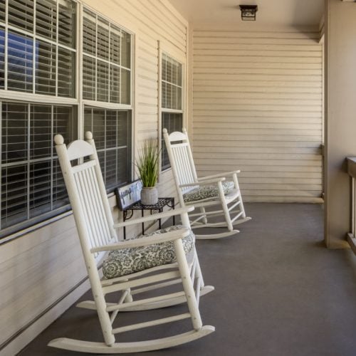 Apartment balcony with two rocking chairs