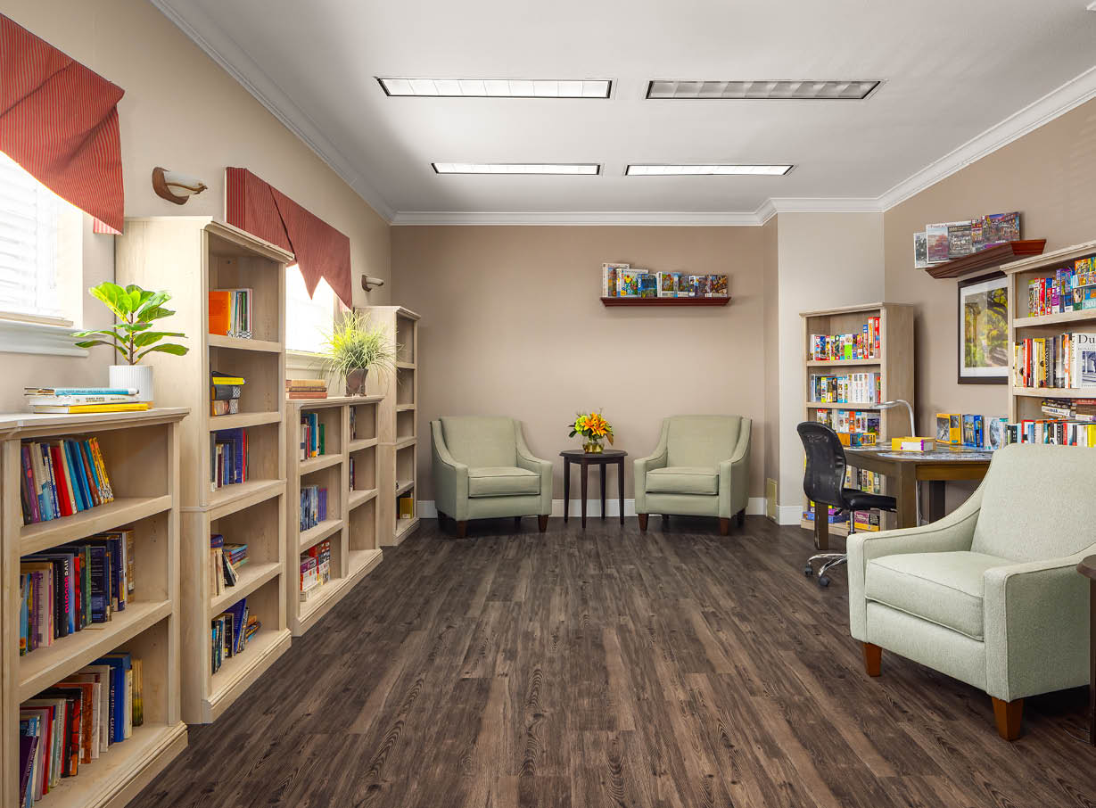 The library has many shelves of books as well as a puzzle table