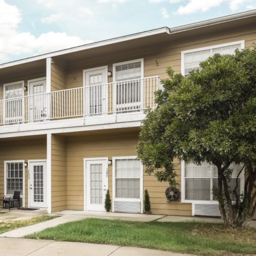 Two-story senior living apartment building includes patios and balconies
