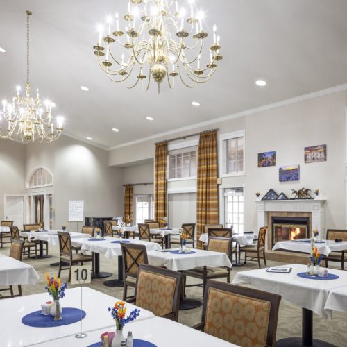 Large and elegant dining room with high ceilings, a piano and a fireplace in San Antonio, Texas