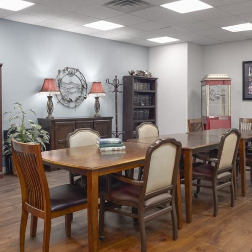 Gathering room has a large table, popcorn machine and book shelves