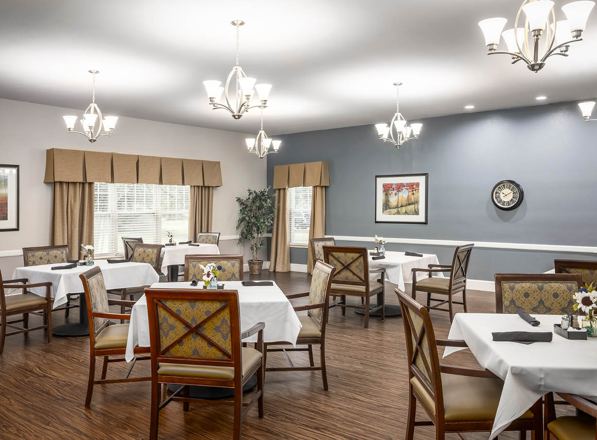 Large dining room with multiple tables and white tablecloths in Keller, Texas