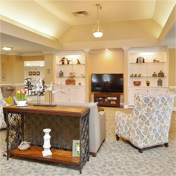 Lounge area with built-in shelving, comfortable seating and a big-screen TV in Columbus, Ohio.