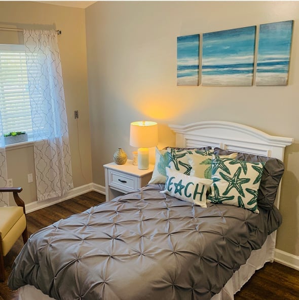 Model studio apartment featuring a large bed and window.