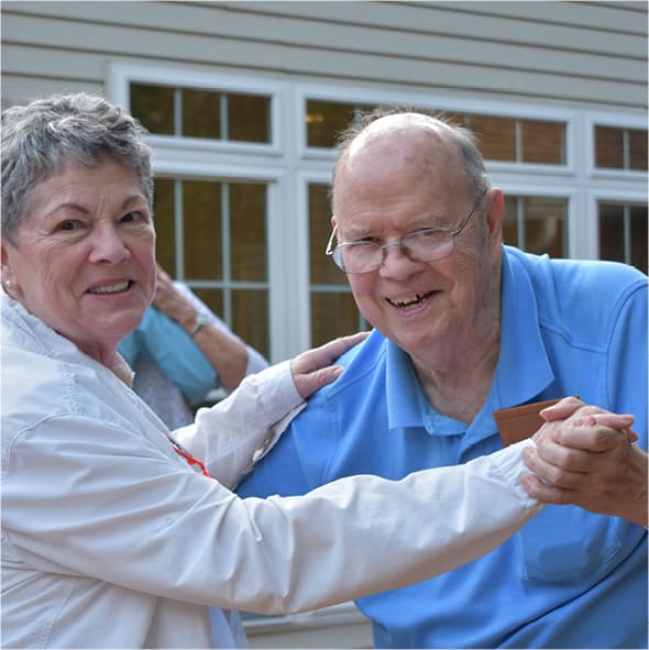 Residents smiling during a dance lesson in Anderson, Indiana.