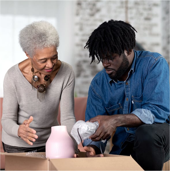 Grandson helping his grandmother unpack in her new home.