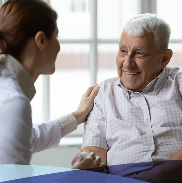 A senior man talking with a community director.