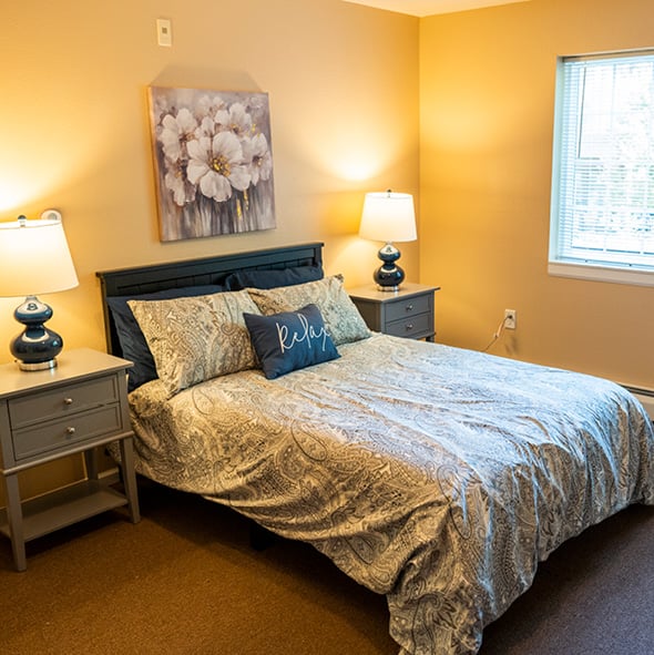 Bedroom in an assisted living community with a large bed in Maple Grove, Minnesota.
