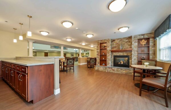 A lounge area with fireplace and sitting area at the Harrison, a senior living community in Indianapolis, Indiana.