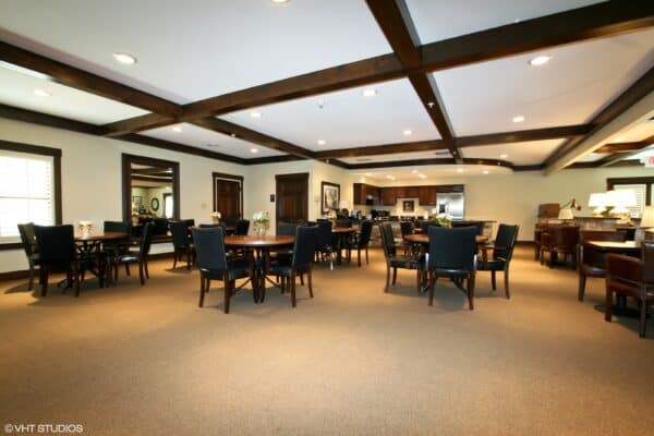 Dining room with mahogany beams and ample seating at senior living community in St. Joseph, Missouri.
