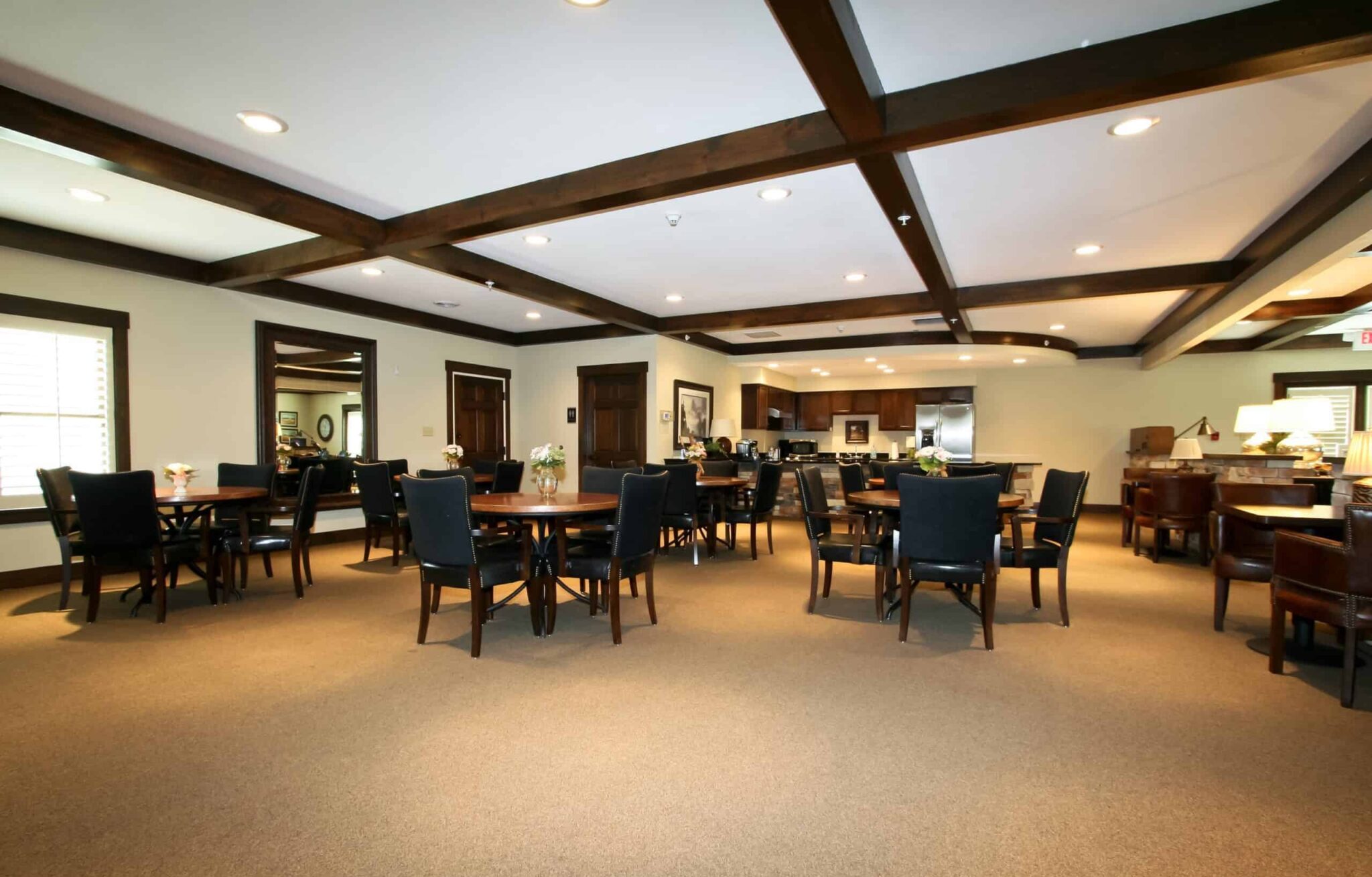Dining room with mahogany beams and ample seating at senior living community in St. Joseph, Missouri