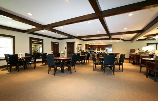 Dining room with mahogany beams and ample seating at senior living community in St. Joseph, Missouri.