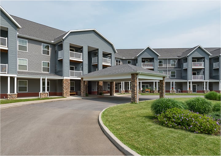 Entrance to assisted living community with stonework and an overpass in Oneonta, New York.