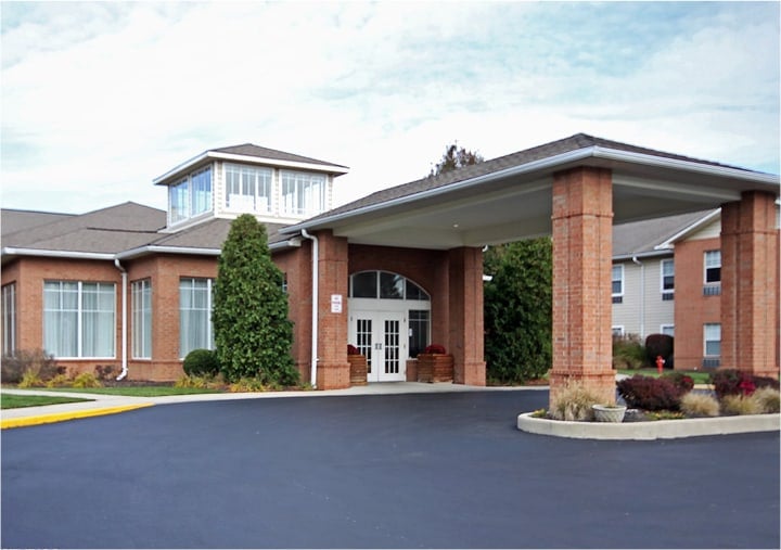Senior living community building with brick, a grand portico with columns and balconies in Fairfield, Ohio.