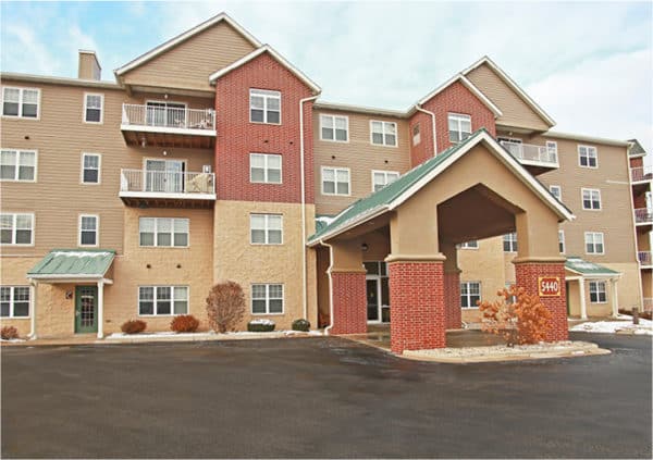 Senior living community entrance in Fitchburg, Wisconsin, with covered entryway and balconies.
