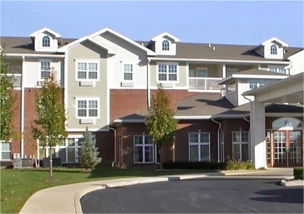Front entrance of a senior living facility with covered, circular driveway in Perrysburg, Ohio.