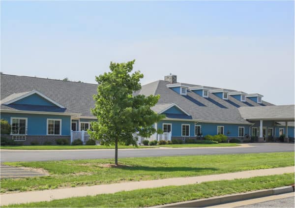 Front entrance of a senior living facility in Wisconsin Rapids, Wisconsin with covered walkway.