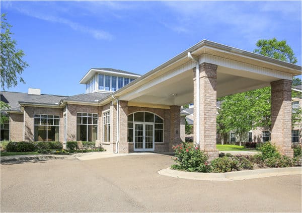 Brick building with large windows, portico entrance and landscaping in Ridgeland, Mississippi.