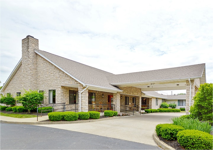 The entrance to a senior living community in Columbus, Ohio with brick facade and white columns.