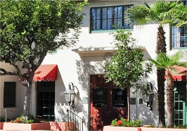 Front entrance of a senior living facility in Santa Barbara, California with a palm tree at the entrance.