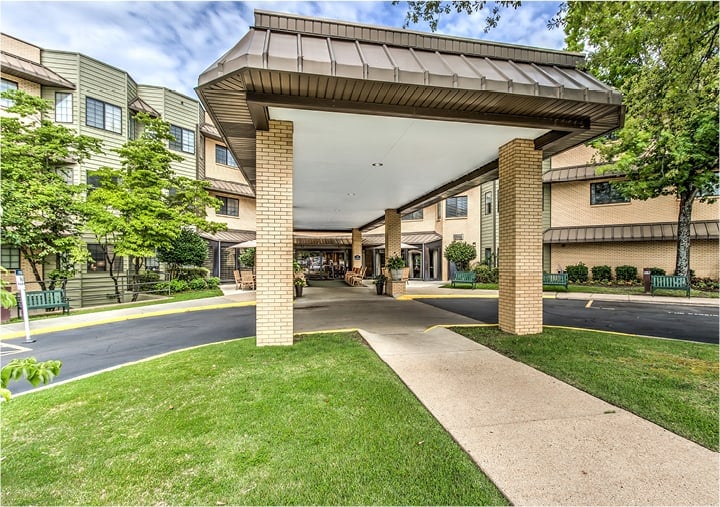 Front entrance of a senior living facility in Hot Springs, Arkansas with covered circular drive.