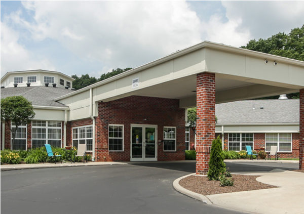Entrance to senior living community in Lambertville, Michigan with red brick exterior.