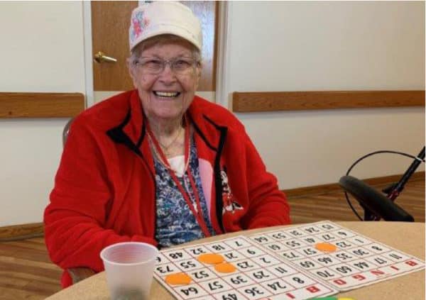 A smiling resident playing a round of bingo in the activity center in Lambertville, Michigan.